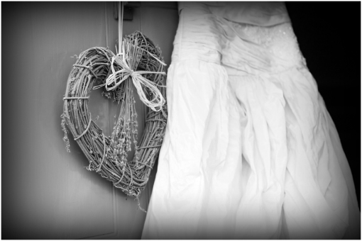 Wicker Heart and Bridal Gown Hanging on Door